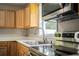Updated kitchen features modern appliances and wood cabinets at 415 Lucille St, Bartow, FL 33830