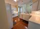Kitchen with white cabinets, breakfast bar, and hardwood floors at 1045 Caravan Loop, Polk City, FL 33868