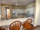 Kitchen with white cabinets, a breakfast bar, and hardwood floors at 1045 Caravan Loop, Polk City, FL 33868