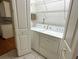 Laundry room with washer, dryer, and shelving at 1045 Caravan Loop, Polk City, FL 33868