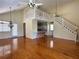 Open living room with loft, hardwood floors, and kitchen bar at 1045 Caravan Loop, Polk City, FL 33868