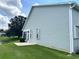 Side view of house showcasing vinyl siding and patio at 1045 Caravan Loop, Polk City, FL 33868
