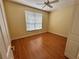 Bedroom with hardwood floors and a ceiling fan at 1045 Caravan Loop, Polk City, FL 33868