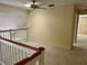 Spacious loft area with carpeted flooring and ceiling fan at 1045 Caravan Loop, Polk City, FL 33868
