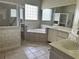 Bathroom with corner bathtub, shower, and double vanity at 1045 Caravan Loop, Polk City, FL 33868