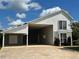 Two-story home with attached garage and covered carport at 1045 Caravan Loop, Polk City, FL 33868