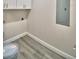 Clean laundry room with white cabinets and gray vinyl flooring at 112 5Th Se St, Fort Meade, FL 33841