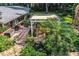 Relaxing patio with pergola, stone flooring, lush landscaping, and pond at 7525 Catherine Dr, Lakeland, FL 33810