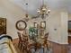 Elegant dining room with a large table, chandelier, and hardwood floors at 3141 Stonewater Dr, Lakeland, FL 33803