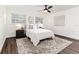 Cozy bedroom with a comfortable bed, dark hardwood floors and ceiling fan at 4618 Crestview Ln, Lakeland, FL 33813