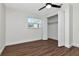 Spacious bedroom with wood-look floors, closet, and ceiling fan at 4618 Crestview Ln, Lakeland, FL 33813