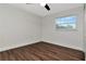 Bright bedroom with wood-look flooring and large window at 4618 Crestview Ln, Lakeland, FL 33813