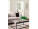 Living room showcases a contemporary coffee table and plush gray sofa at 4618 Crestview Ln, Lakeland, FL 33813