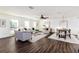 Bright living room features hardwood floors, comfy seating, and large windows at 4618 Crestview Ln, Lakeland, FL 33813