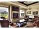 Comfortable lounge with leather seating, fireplace and large TV at 6205 Raven Run, Lakeland, FL 33809