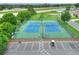 Aerial view of two well-maintained tennis courts with surrounding parking at 6205 Raven Run, Lakeland, FL 33809