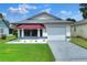Single-story home with attached garage and awning at 6205 Raven Run, Lakeland, FL 33809