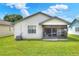 Single story home with screened patio and AC unit at 6205 Raven Run, Lakeland, FL 33809
