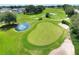 Aerial view of a putting green and sand traps on a well-maintained golf course at 6205 Raven Run, Lakeland, FL 33809