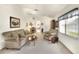 Living room with beige sofa, armchairs, coffee table and carpeted floor at 6205 Raven Run, Lakeland, FL 33809