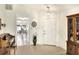 Inviting entryway with tile flooring, piano, and views to the dining area at 6205 Raven Run, Lakeland, FL 33809