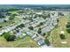 Aerial view of a house nestled in a community with a golf course nearby at 6205 Raven Run, Lakeland, FL 33809