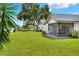 Spacious backyard with screened patio and lush lawn at 6205 Raven Run, Lakeland, FL 33809