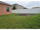 Simple backyard with a grassy area and a small garden at 1109 Brenton Manor Dr, Winter Haven, FL 33881