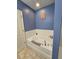 Relaxing garden tub and neutral-toned bathroom at 1109 Brenton Manor Dr, Winter Haven, FL 33881
