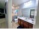 Clean bathroom with vanity, shower/tub combo, and ocean-themed curtain at 1109 Brenton Manor Dr, Winter Haven, FL 33881