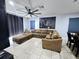 Living room with L-shaped sectional sofa and large art at 1109 Brenton Manor Dr, Winter Haven, FL 33881