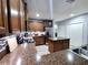 Eat-in kitchen with dark wood cabinets and granite counters at 1109 Brenton Manor Dr, Winter Haven, FL 33881