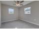 Well-lit bedroom featuring neutral walls, carpet flooring, and a ceiling fan at 2350 E Washington St, Bartow, FL 33830