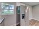 Modern kitchen with stainless steel refrigerator, white cabinets and a window view at 2350 E Washington St, Bartow, FL 33830