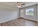 Living room with vinyl flooring, ceiling fan and front door view at 2350 E Washington St, Bartow, FL 33830