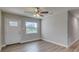 Living room with vinyl flooring, ceiling fan and front door view at 2350 E Washington St, Bartow, FL 33830