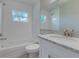 Clean bathroom with white subway tiles, marble vanity, and a bathtub at 2350 E Washington St, Bartow, FL 33830
