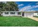Charming ranch home with white brick exterior and landscaped lawn at 2350 E Washington St, Bartow, FL 33830
