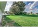 Expansive grassy backyard with a large tree providing shade at 2350 E Washington St, Bartow, FL 33830