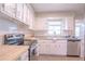 Updated kitchen featuring white cabinets, stainless steel appliances, and light countertops at 121 Coleman Rd, Winter Haven, FL 33880