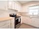 Bright kitchen with white cabinets, stainless steel appliances, and wood countertops at 121 Coleman Rd, Winter Haven, FL 33880