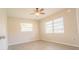 Spacious bedroom with ceiling fan and two windows, offering great natural light at 121 Coleman Rd, Winter Haven, FL 33880