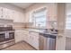 Modern kitchen featuring stainless steel appliances and white cabinetry at 121 Coleman Rd, Winter Haven, FL 33880