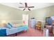Bright bedroom featuring a double bed, ceiling fan, and access to a bathroom at 13958 Hatchineha Rd, Haines City, FL 33844
