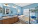 Bathroom features double vanity, bathtub, and shower at 13958 Hatchineha Rd, Haines City, FL 33844