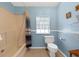 Simple bathroom with a shower/tub, toilet, and a window for natural light at 13958 Hatchineha Rd, Haines City, FL 33844