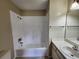 Clean bathroom with a bathtub, sink, and tiled walls at 6128 Topher Trl # 6128, Mulberry, FL 33860