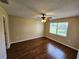 Bedroom with wood-look flooring and large window at 6128 Topher Trl # 6128, Mulberry, FL 33860