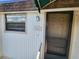 Exterior view of condo building with a covered entryway and screen door at 6128 Topher Trl # 6128, Mulberry, FL 33860