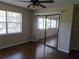 Bright bedroom with wood-look floors and sliding glass doors leading to a sunroom at 6128 Topher Trl # 6128, Mulberry, FL 33860